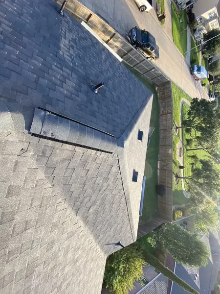 Freshly capped hip line with ridge vent on a Katy repair