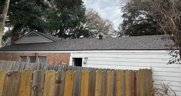 Side slope of the new roof seen over the back fence