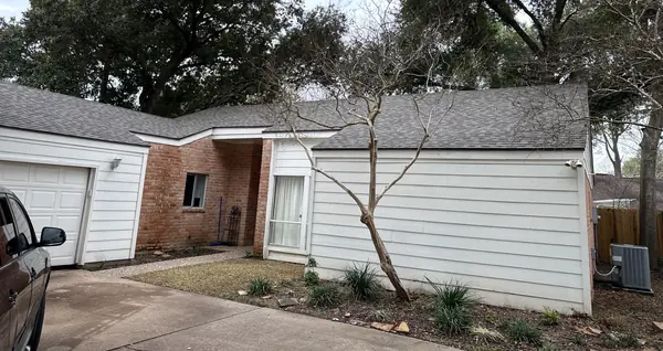 Front of the house and garage with the finished roof