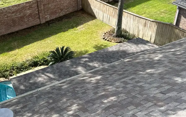 New roof edge and fenced backyard on a two-story house in northwest Houston