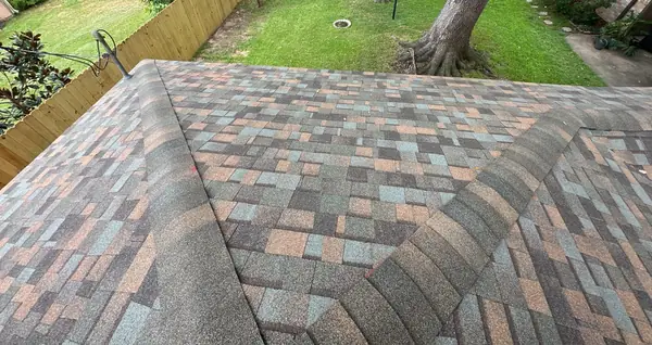 Brick chimney on a new shingle roof in Missouri City