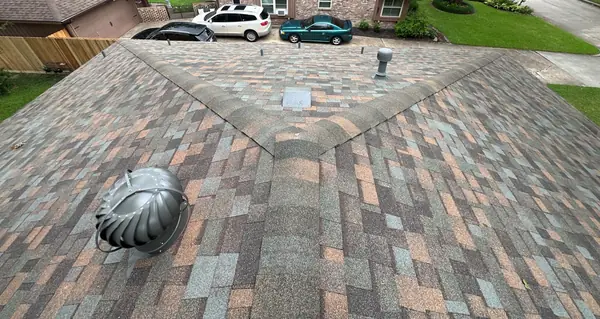 Side elevation of a Missouri City home with a new roof and gutters