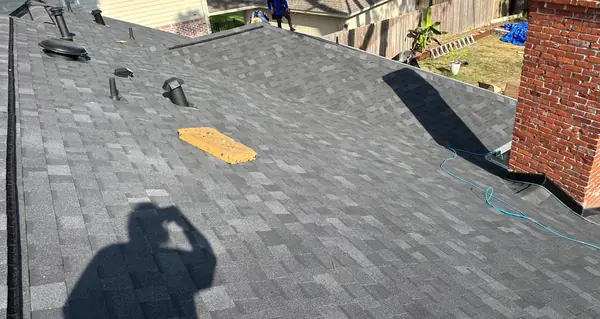 Rear slope of a replaced roof over a treed backyard in Houston, TX