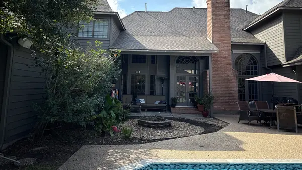 Rear elevation showing the chimney and new gray-brown shingles, Kingwood 77345