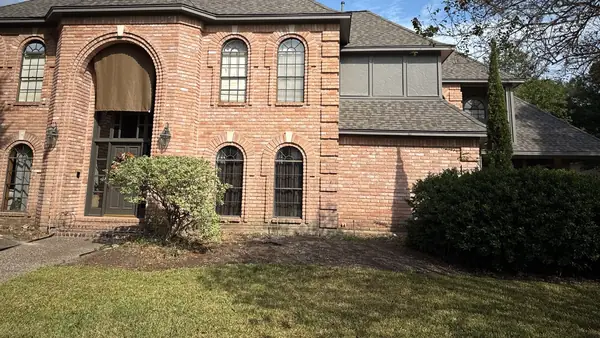 Front elevation of the brick home with the new roof