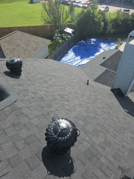 Side slope of a replaced roof with new gutters in League City