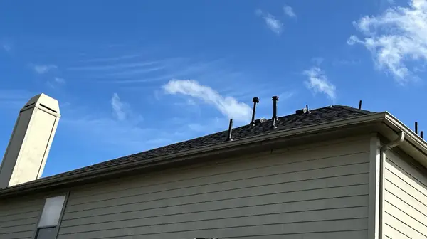 Moire Black ridge and chimney on a two-story Katy roof