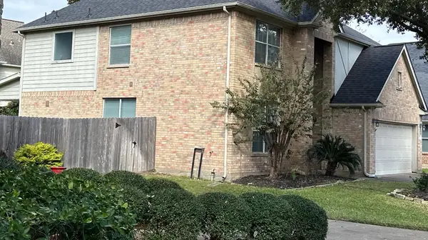 Front corner of a brick-and-siding home with a new black roof, Katy 77450