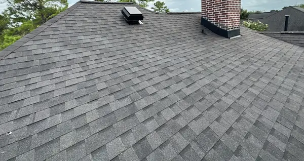Chimney with new flashing on the completed roof