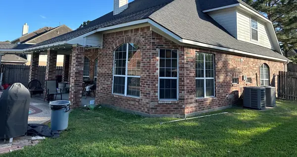 Rear corner of the house with the completed roof above the patio
