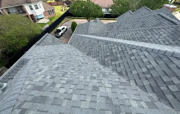 Street-facing slopes of the finished charcoal roof