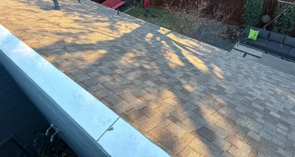 New metal edge where the pitched roof meets the low-slope section