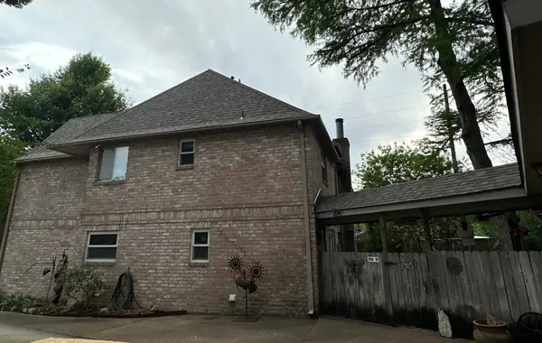 Side view of a replaced hip roof and new gutters in northwest Houston