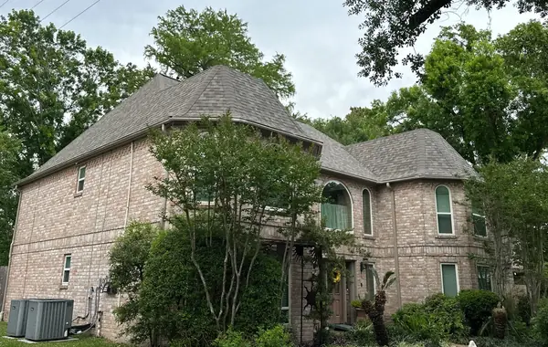 Front corner of a Houston home with a May 2026 roof replacement