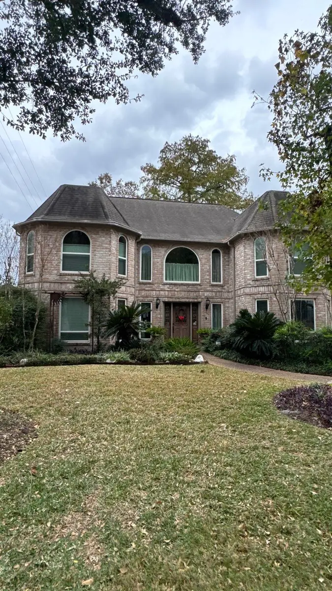 Two-story brick Houston home with a new 50-square shingle roof in 77095