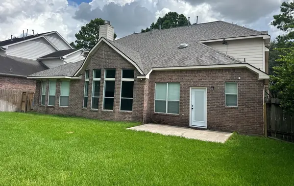Back patio side of a two-story home with a new laminate shingle roof