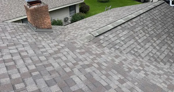 Brick chimney with fresh flashing on a replaced roof in Spring Branch