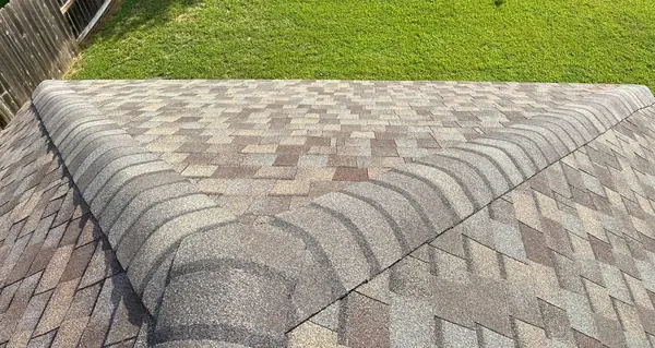 Hip and ridge caps of a new Landmark Pro roof in Cypress
