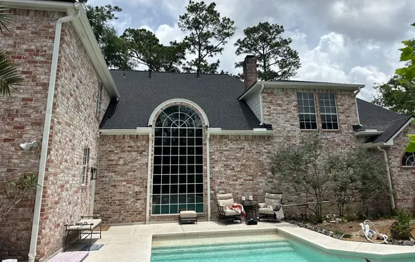 Rear of the house with the pool and new roofline