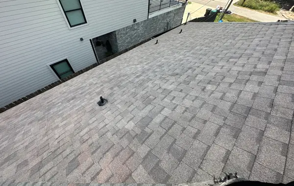 Moire Black architectural shingles on a south Houston roof, looking toward the street
