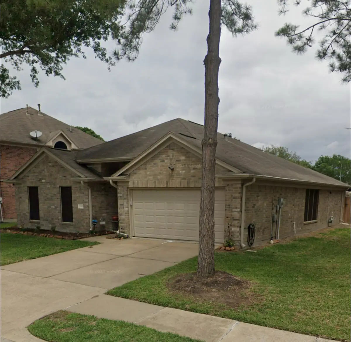 Front of the one-story brick home with the replaced roof