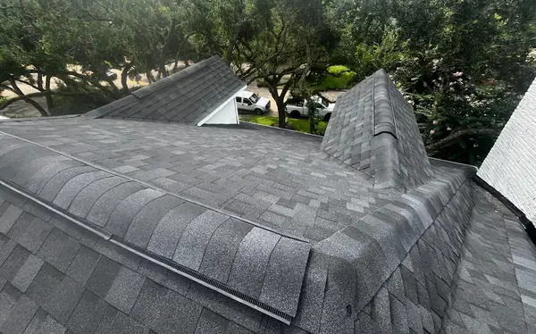 Completed roof slopes with new flashing and ridge caps, Houston TX