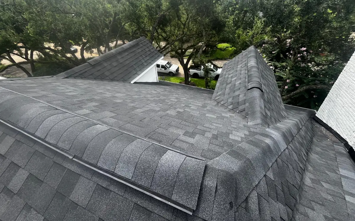 Completed roof slopes with new flashing and ridge caps, Houston TX