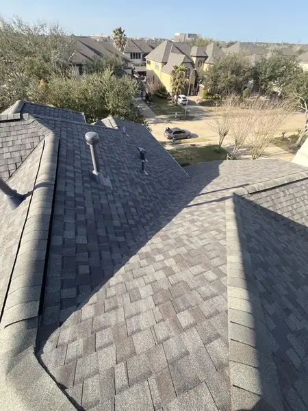 Ridge cap detail on a two-story Sugar Land roof