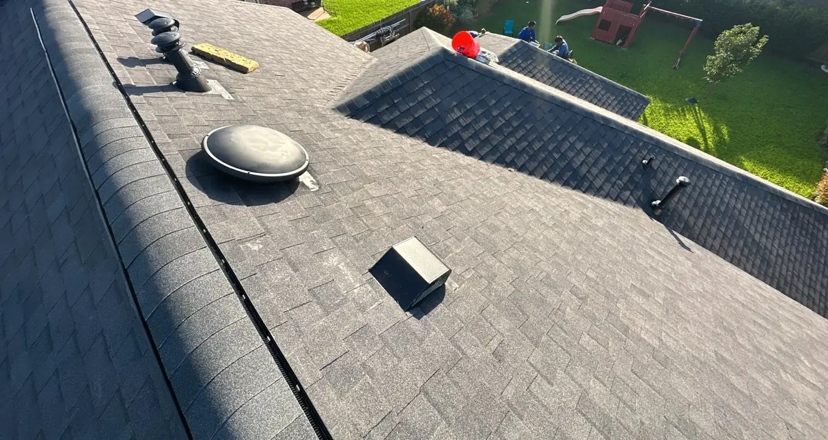 Uniform charcoal laminate roof with new dome vent on a Houston home in 77095