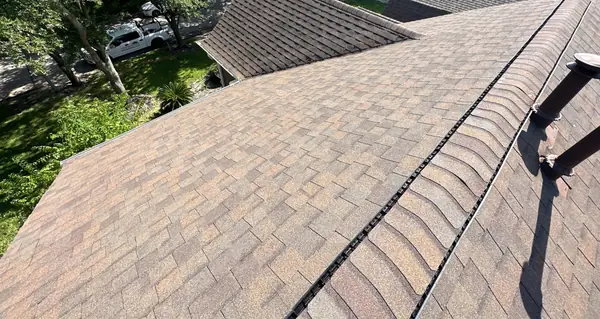 Ridge cap and slope of an August 2025 roof replacement in Houston, TX