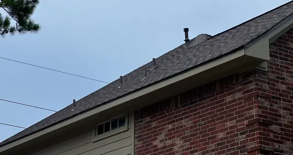 Ridge caps and hip of a new Weathered Wood roof in Cypress