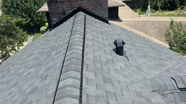 Valley and ridge detail on a black shingle roof in Houston