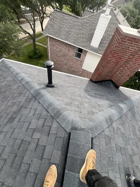 Brick chimney and valley on a new shingle roof in west Houston