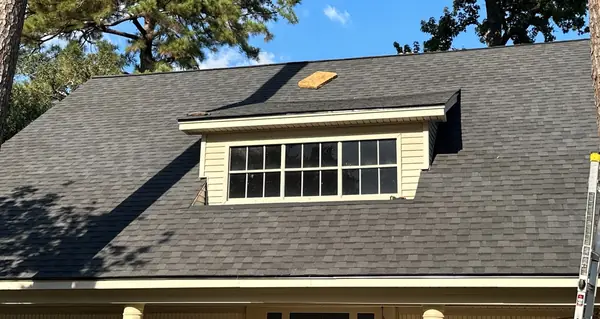 Dormer with new flashing on the completed charcoal roof