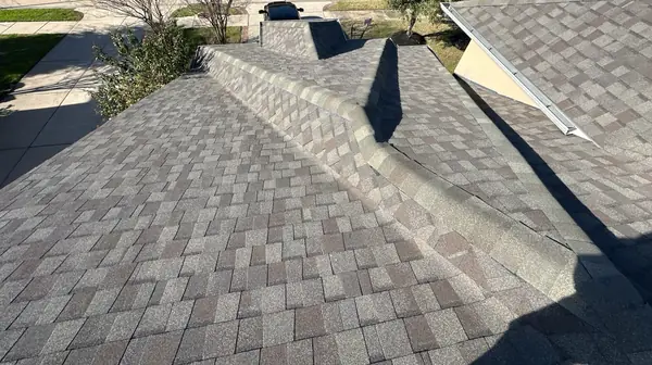 Main ridge of a new gray-brown roof in Katy 77494
