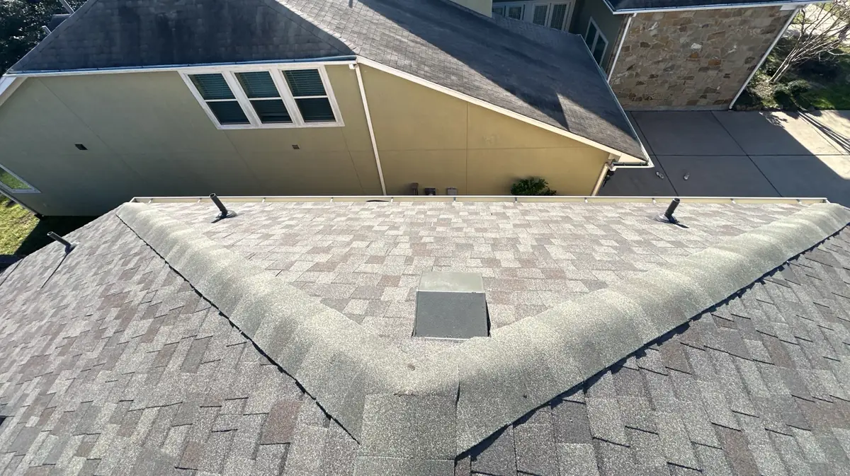 Covered patio roof tied into the main hip of a Katy home