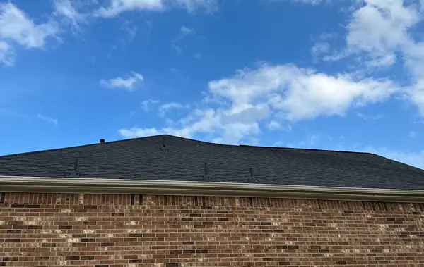 Ridge line above the brick with new charcoal shingles