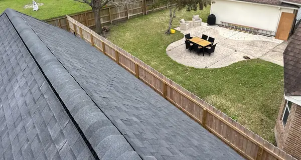 Patio cover and backyard under a replaced roof in Houston, TX