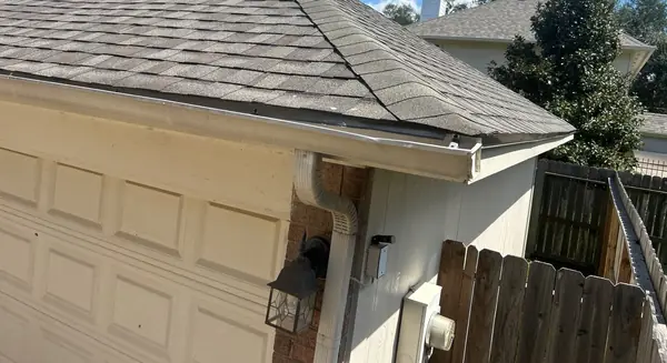 Garage eave with fresh shingles on a December 2024 roof replacement