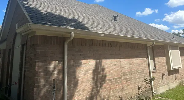 Brick side wall and new shingle roof in northwest Houston