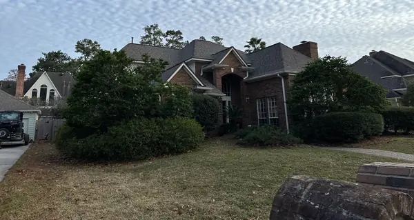 Front of a two-story Kingwood home with a new roof
