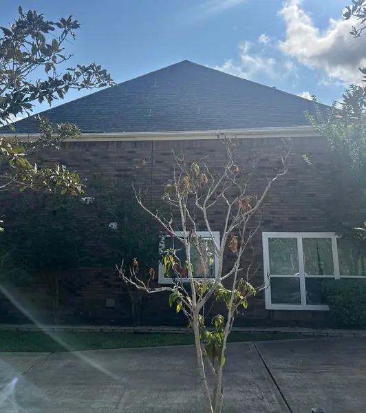 Side slope of a replaced roof with new gutters in Sugar Land