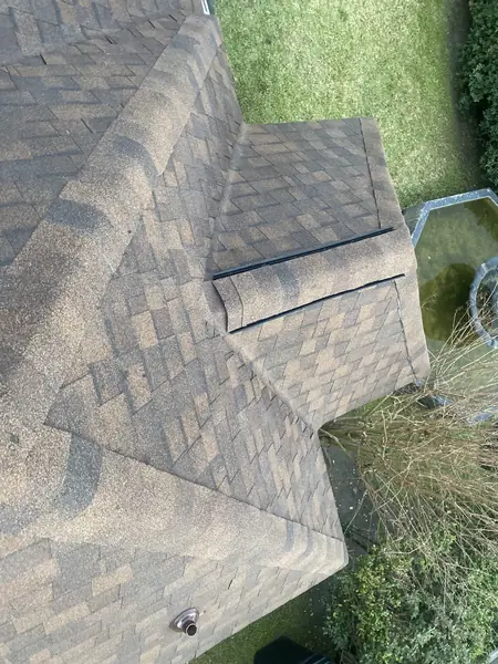 Ridge cap detail on a steep laminate roof in Houston