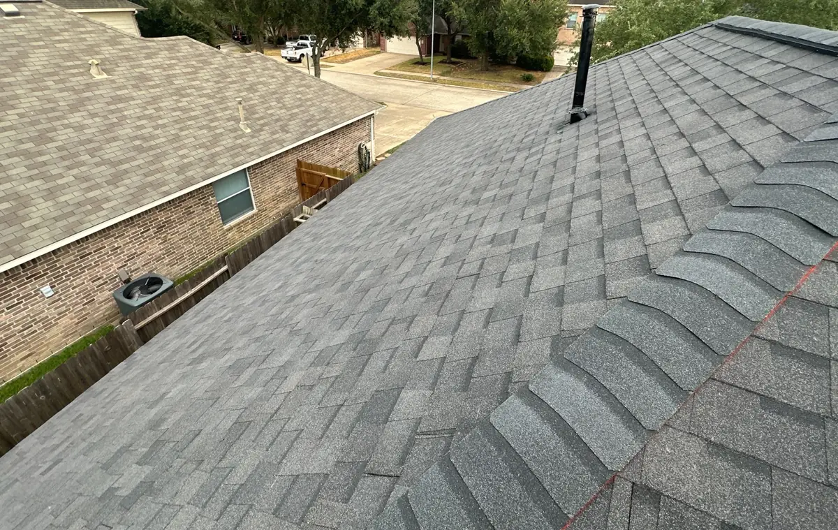 Gray shingle roof with new ridge vent on a Katy home