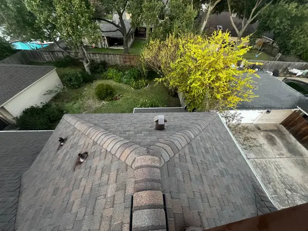 Cross gable and hips of a new charcoal roof in Cypress 77095