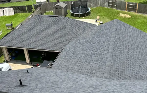 Hip and ridge of a new gray roof in Bridgeland, Cypress