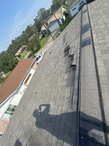 Wind-lifted shingles found during tear-off on a Houston roof