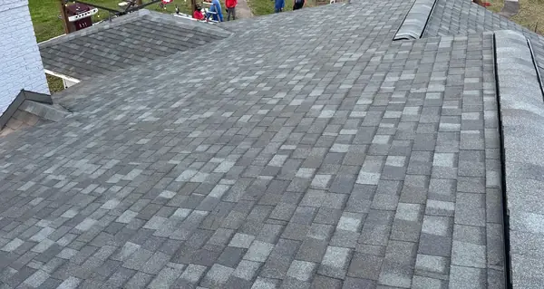 Shingle field with a neighboring roof beyond