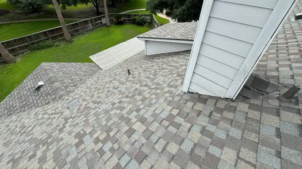 Chimney chase with rebuilt flashing on a replaced Houston roof