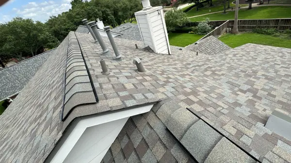 Brick chimney re-flashed on a storm damage roof replacement in Houston, TX